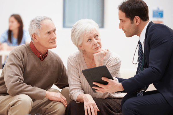 Salesman speaking to an older couple | Waypoint Converts
