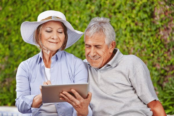 Two senior citizens looking at a tablet | Waypoint Converts
