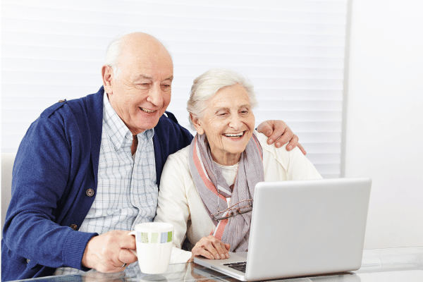 Senior citizens looking at a computer.