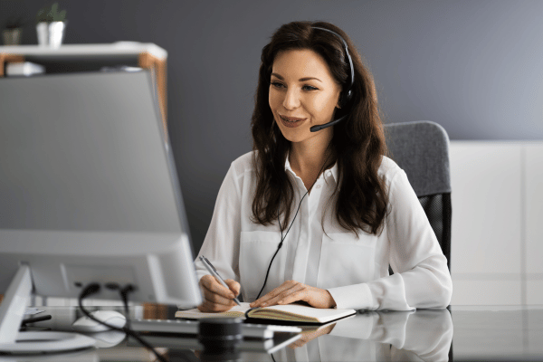 Woman sitting at a desk in front of a computer.