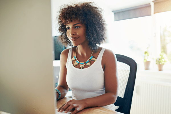 Woman sitting at a desk, working on a computer