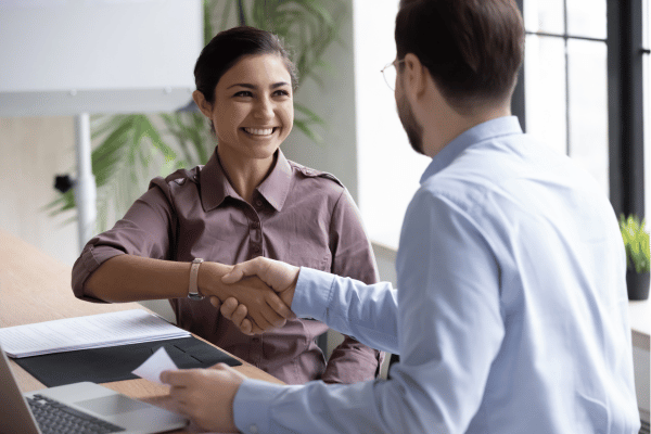 A man and woman shaking hands.