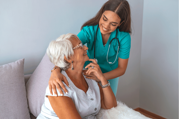 Female nurse comforting an elder woman.